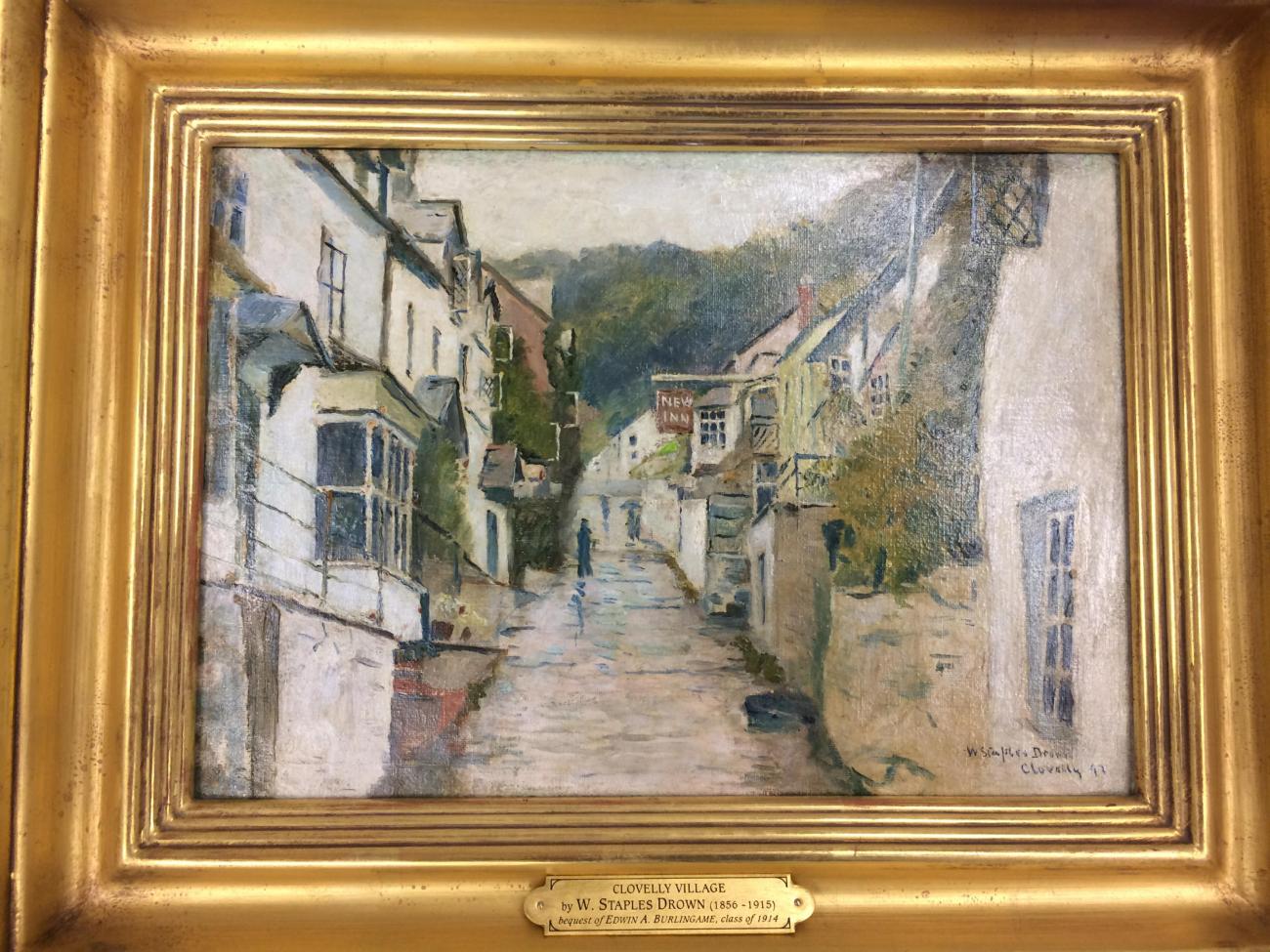 gold framed oil painting of a european village street looking up a hill